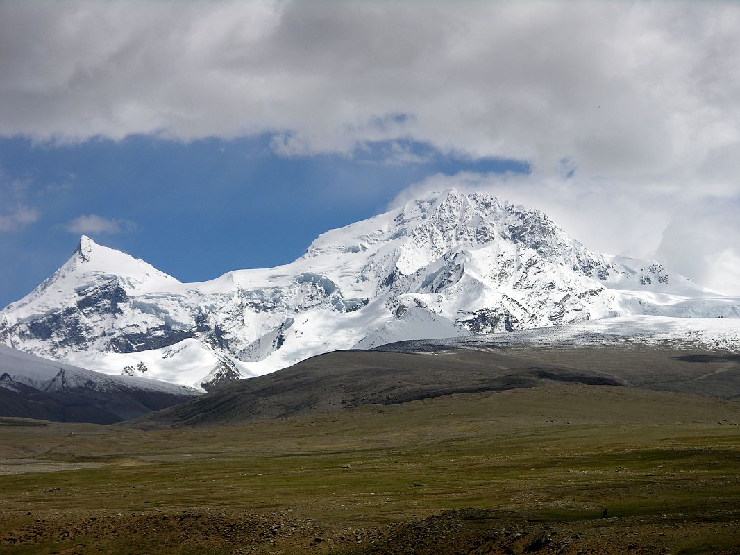 Shishapangma North 01 07 Shishapangma and Phola Ganchen From North Base Camp We drove to Shishapangma Base Camp (5000m), known locally as Chinese Base Camp, pleasantly situated on grassy patch alongside the river, raging in the monsoon. We waited a few hours, and finally the monsoon clouds lifted for a few minutes. On the left is Phola Ganchen (7661m) and to the right is Shishapangma (8012m).